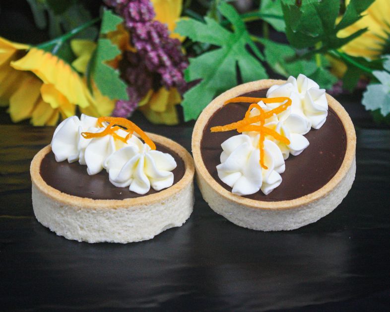 Whittaker dark chocolate orange tarts topped with whipped cream (v)