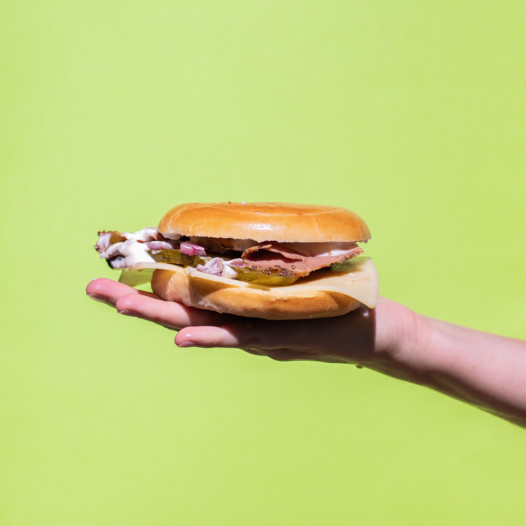 'The New Yorker' Pastrami, Dijon, Swiss Cheese, Pickles & Aioli Bagel